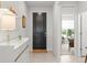 Bright foyer featuring a dark front door and a view of the living area at 9459 Sw 52Nd Loop, Ocala, FL 34481