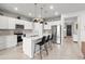 Modern kitchen features white cabinets, stainless steel appliances, and a large island with seating at 9459 Sw 52Nd Loop, Ocala, FL 34481