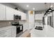 Bright kitchen features stainless steel appliances, white cabinets, and quartz countertops at 9459 Sw 52Nd Loop, Ocala, FL 34481