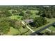 Aerial view of landscaped estate with mature trees, fenced perimeters, and long driveway at 9462 Sw 72Nd Ct, Ocala, FL 34476