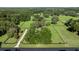 Aerial view of fenced acreage with mature trees and landscaping around the home at 9462 Sw 72Nd Ct, Ocala, FL 34476