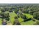 An aerial view of a beautiful estate surrounded by lush greenery and featuring a sparkling pool at 9462 Sw 72Nd Ct, Ocala, FL 34476