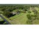 Overhead shot showcasing the home's location within a verdant, fenced property with mature trees at 9462 Sw 72Nd Ct, Ocala, FL 34476