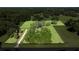 Aerial view of the fenced property featuring lush greenery, mature trees, and expansive lawn areas at 9462 Sw 72Nd Ct, Ocala, FL 34476