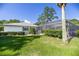 Screened-in pool area with manicured hedges and a view of the home's exterior at 9462 Sw 72Nd Ct, Ocala, FL 34476
