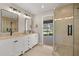 Bathroom featuring double sinks and shower with glass door at 9462 Sw 72Nd Ct, Ocala, FL 34476