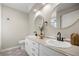 A bathroom with double sinks, round mirrors, and stylish geometric floor tiles at 9462 Sw 72Nd Ct, Ocala, FL 34476