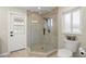 Bright bathroom shower featuring a glass door and a corner seat at 9462 Sw 72Nd Ct, Ocala, FL 34476