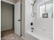 Bright bathroom with a tub and shower combination, black fixtures, and decorative tile flooring at 9462 Sw 72Nd Ct, Ocala, FL 34476