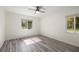 Sunlit bedroom features tile floors and views of the surrounding greenery from two windows at 9462 Sw 72Nd Ct, Ocala, FL 34476