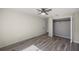 A bedroom with wood-look flooring, a ceiling fan, and a closet at 9462 Sw 72Nd Ct, Ocala, FL 34476