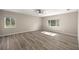 This large, bright bedroom has two windows and wood-look tile floors at 9462 Sw 72Nd Ct, Ocala, FL 34476