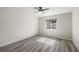 A bedroom with a ceiling fan and a window looking out to a fenced yard at 9462 Sw 72Nd Ct, Ocala, FL 34476