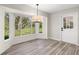 Bright dining area with large windows offering outdoor views, and contemporary lighting fixture at 9462 Sw 72Nd Ct, Ocala, FL 34476