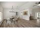 Dining room features stylish chandelier, modern furnishings, and wood-look flooring at 9462 Sw 72Nd Ct, Ocala, FL 34476