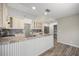 Inviting kitchen with custom island, modern appliances, and a view to the dining area at 9462 Sw 72Nd Ct, Ocala, FL 34476