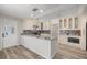 Charming kitchen features an island with breakfast bar, and modern stainless steel appliances at 9462 Sw 72Nd Ct, Ocala, FL 34476