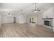 Spacious living area featuring wood-look floors, fireplace, and sliding glass doors to the outside at 9462 Sw 72Nd Ct, Ocala, FL 34476