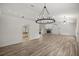 Open concept living space featuring high ceilings, wood-look floors, and plenty of natural light at 9462 Sw 72Nd Ct, Ocala, FL 34476