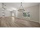 Spacious living room features a vaulted ceiling, modern chandeliers, and wood-look floors at 9462 Sw 72Nd Ct, Ocala, FL 34476