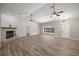 Open living area with brick fireplace, wood-look flooring, and abundant natural light at 9462 Sw 72Nd Ct, Ocala, FL 34476