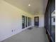 Covered patio area with sliding glass doors and a screened entrance to the backyard at 9462 Sw 72Nd Ct, Ocala, FL 34476