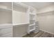 A walk-in closet with an integrated shelf and drawer system at 9462 Sw 72Nd Ct, Ocala, FL 34476