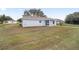 A backyard featuring a newly built home with a covered patio and fresh grass at 9731 Bahia Rd, Ocala, FL 34472