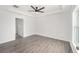 Bright bedroom with tray ceiling, ceiling fan, and natural light at 9731 Bahia Rd, Ocala, FL 34472