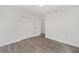 Clean, bright bedroom with luxury vinyl plank flooring, white trim and neutral walls, plus double door closet at 9731 Bahia Rd, Ocala, FL 34472