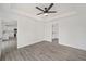 Bright bedroom with tray ceiling and access to the kitchen and bathroom at 9731 Bahia Rd, Ocala, FL 34472