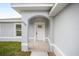 A close-up of the front door with an arched entryway and the house number at 9731 Bahia Rd, Ocala, FL 34472
