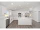 Bright, modern kitchen with white cabinets, stainless steel appliances and island at 9731 Bahia Rd, Ocala, FL 34472