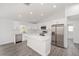 Modern kitchen featuring white cabinets, stainless steel appliances, and central island at 9731 Bahia Rd, Ocala, FL 34472