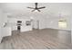 Inviting living area featuring wood-look floors, an open kitchen, and lots of natural light at 9731 Bahia Rd, Ocala, FL 34472