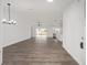 Bright, open living room with wood-look floors and sliding glass doors to the backyard at 9731 Bahia Rd, Ocala, FL 34472