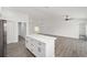 Open-concept living room and kitchen with island and modern ceiling fan at 9731 Bahia Rd, Ocala, FL 34472