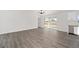 Spacious living area featuring wood-look floors and sliding glass doors to the backyard at 9731 Bahia Rd, Ocala, FL 34472