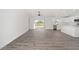 Bright living area showcasing wood-look floors and sliding glass doors to the backyard at 9731 Bahia Rd, Ocala, FL 34472