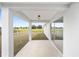 A view from the covered patio into the grassy backyard and out to the surrounding neighborhood at 9731 Bahia Rd, Ocala, FL 34472