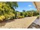 Landscaped backyard with trees and decorative rock at 9853 Se 175Th Pl, Summerfield, FL 34491
