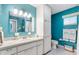 Bright bathroom with built-in vanity, storage cabinet and teal painted walls at 9853 Se 175Th Pl, Summerfield, FL 34491