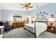 Comfortable bedroom features soft lighting, an ensuite bathroom, and a large window at 9853 Se 175Th Pl, Summerfield, FL 34491