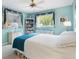 Comfortable bedroom with two windows, and built-in bookshelf at 9853 Se 175Th Pl, Summerfield, FL 34491