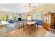 View of the dining area and kitchen from the comfortably furnished living room at 9853 Se 175Th Pl, Summerfield, FL 34491