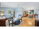 Spacious open-concept living area with hardwood floors, classic decor, and an abundance of natural light at 9853 Se 175Th Pl, Summerfield, FL 34491