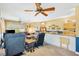 Inviting living room boasts a ceiling fan, comfortable seating, and plenty of natural light at 9853 Se 175Th Pl, Summerfield, FL 34491
