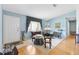 Bright and airy living room featuring hardwood floors and ample natural light, creating a warm atmosphere at 9853 Se 175Th Pl, Summerfield, FL 34491