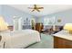 Spacious main bedroom with wood furnishings, ensuite bathroom and walk-in closet at 9853 Se 175Th Pl, Summerfield, FL 34491