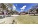 Beautiful backyard featuring a screened-in patio, well-maintained lawn, and mature trees for shade at 10528 Sw 27Th Ave, Ocala, FL 34476